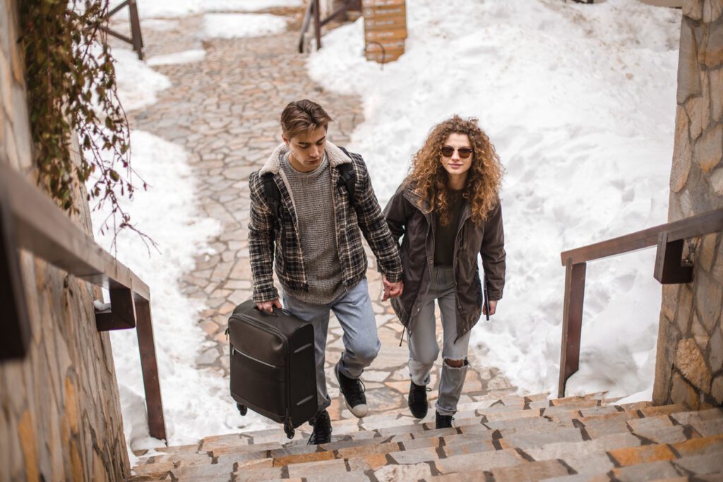 Young couple arriving to a vacation rental in winter