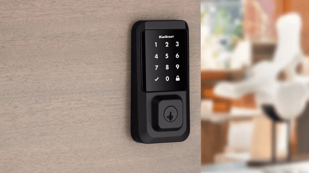 A close-up of a Kwikset smart lock with a touchscreen keypad mounted on a wooden door. This image showcases secure, keyless access solutions and highlights RemoteLock's integration with top lock brands for streamlined property management.